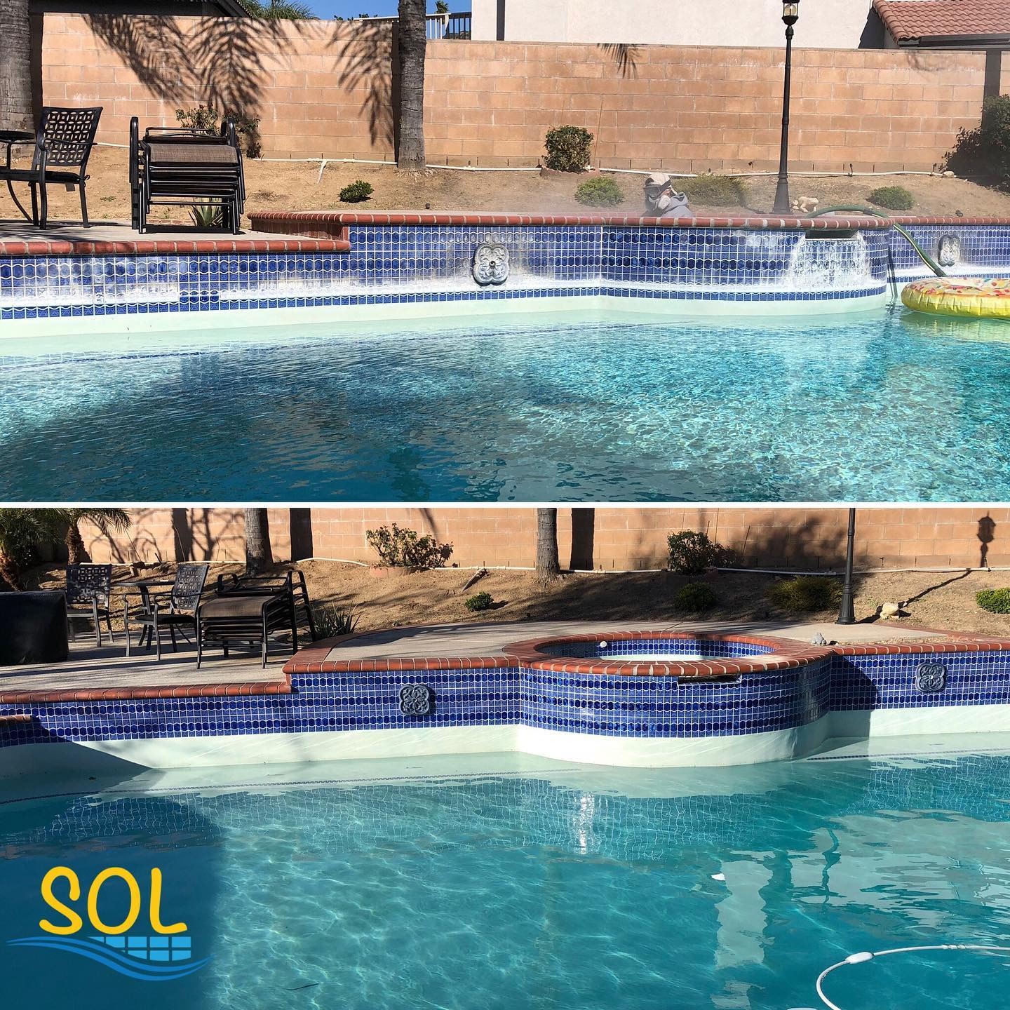 Swimming pool with blue tiles and waterfall feature in backyard setting